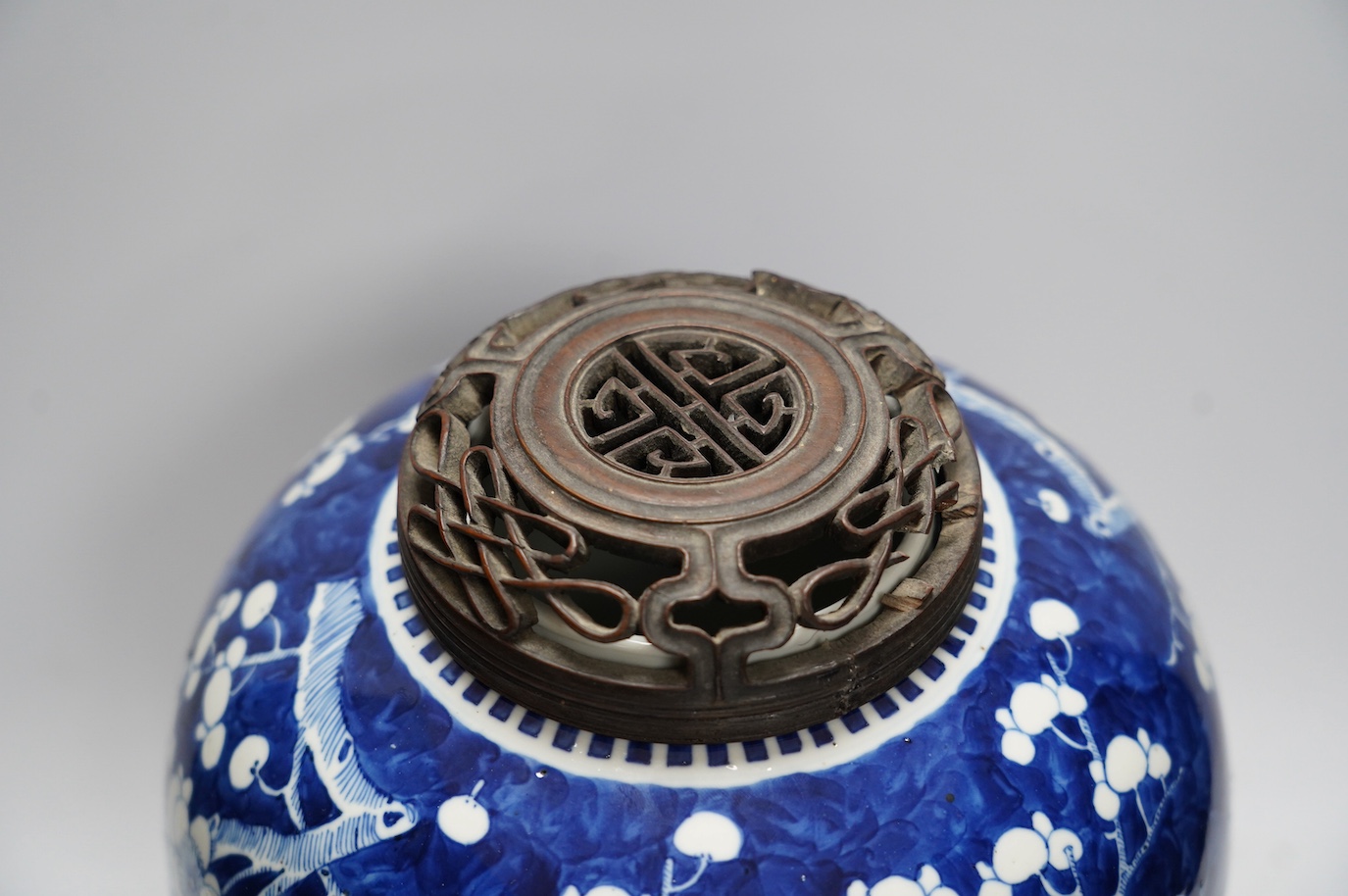 A 19th century Chinese blue and white ginger jar with hardwood stand and cover, overall 30cm high. Condition - jar and stand good, cover repaired